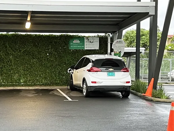 White Chevrolet Bolt EV parked at an EV charging station