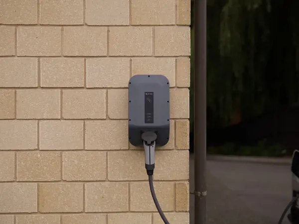 Wall-mounted Level 2 EV charger on an exterior wall