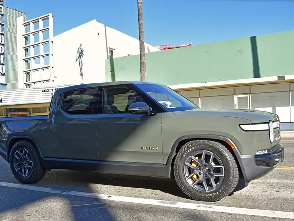 Rivian R1T electric pickup truck parked on a city street